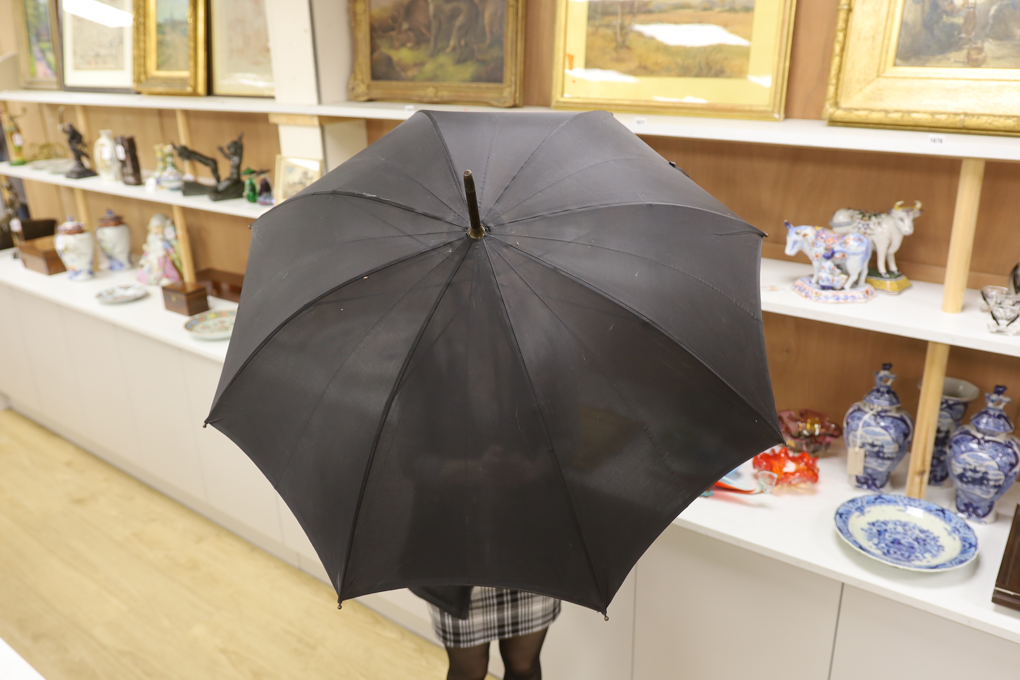 A Chinese white metal handled umbrella with dragon decoration, 94cm long